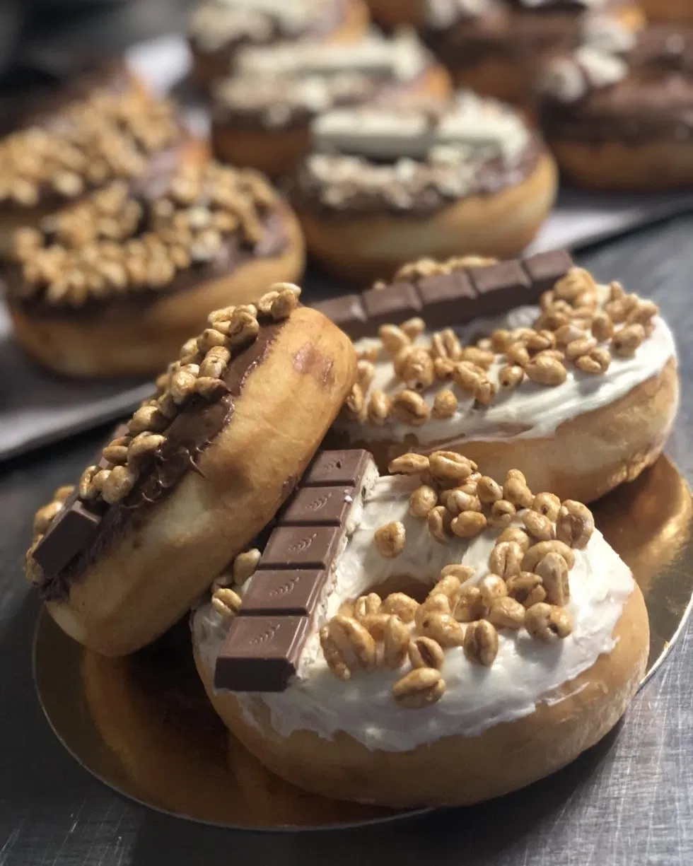 Donuts garnis de chantilly, blé soufflé caramélisé et barre de chocolat au lait